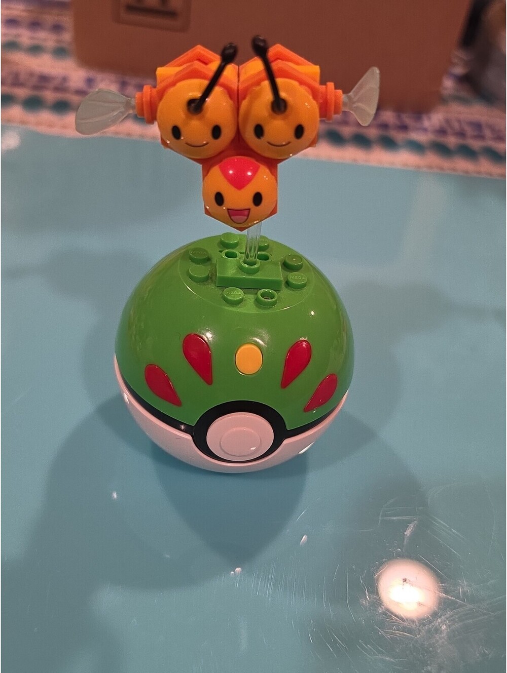 Pokémon Combee Plastic Figure on Green Poké Ball Base, Yellow/Black/Orange